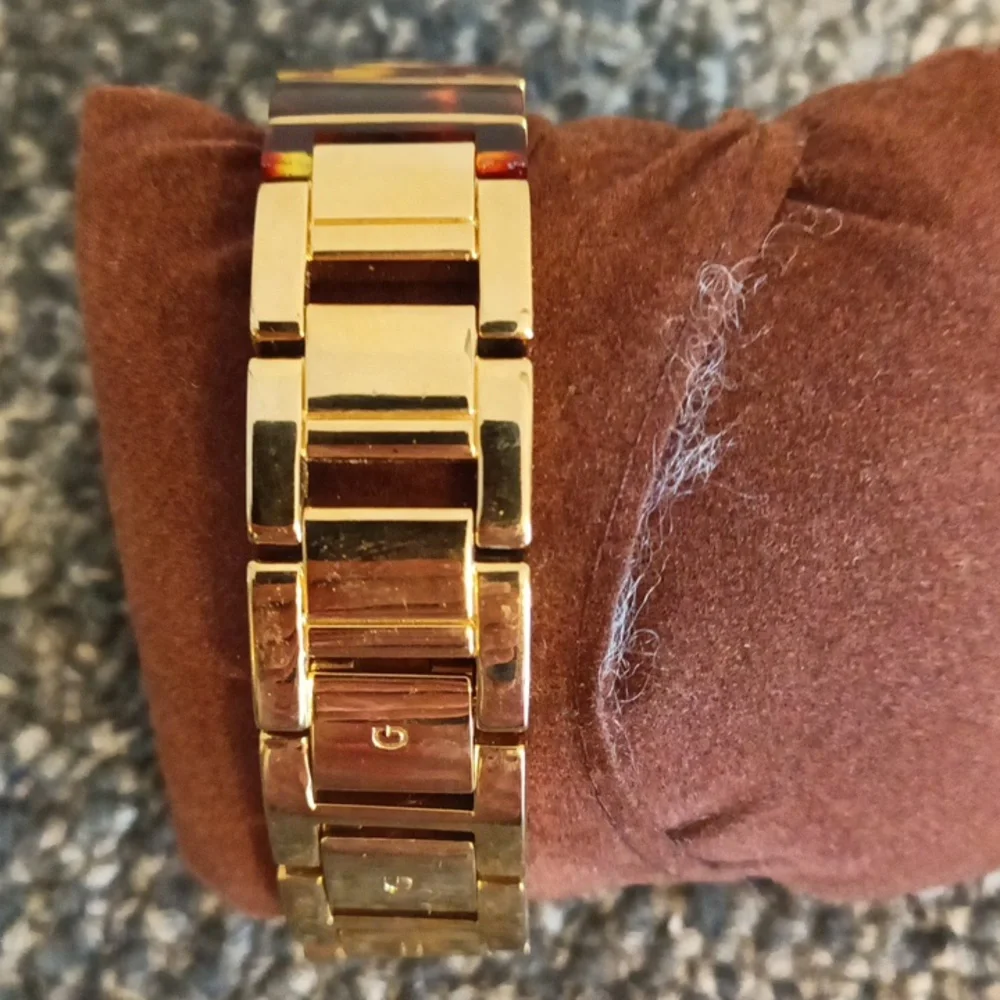 Guess gold tone crystal and tortoise shell womens iconic bracelet watch